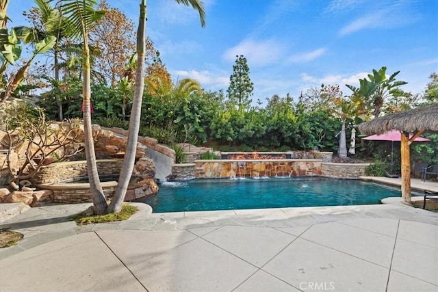 view of pool with pool water feature and a patio area