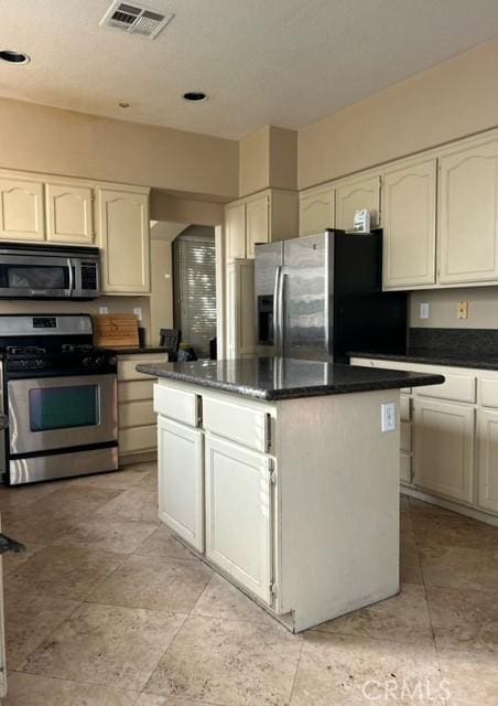 kitchen featuring a center island, white cabinets, and appliances with stainless steel finishes