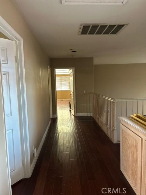 corridor featuring dark hardwood / wood-style flooring