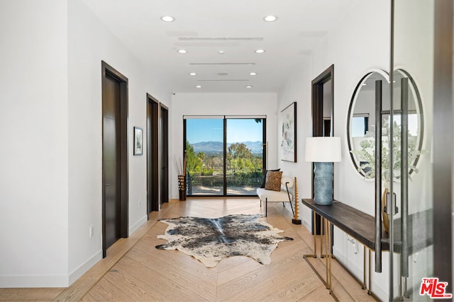 corridor with light hardwood / wood-style floors