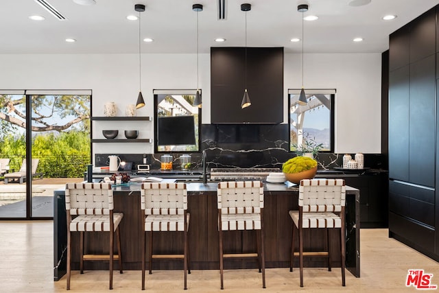 kitchen featuring pendant lighting, plenty of natural light, and backsplash