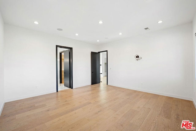 unfurnished room with light wood-type flooring