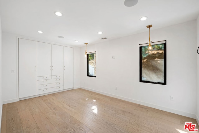 unfurnished bedroom with light wood-type flooring