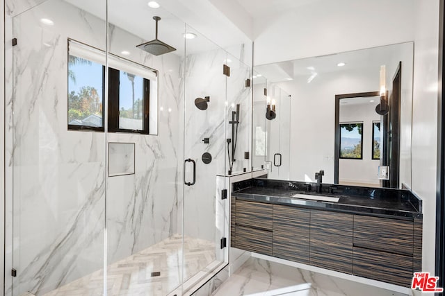 bathroom featuring vanity and an enclosed shower