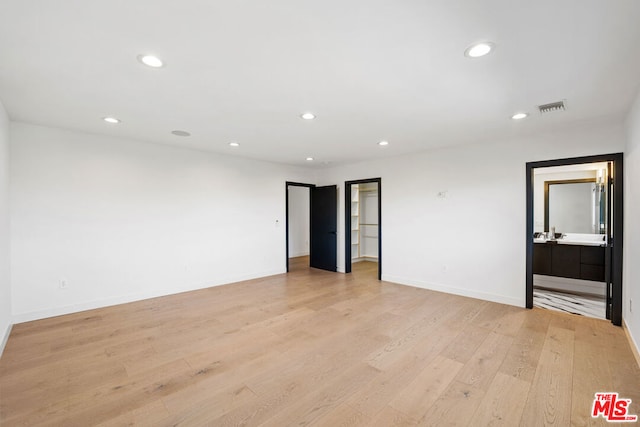 spare room with light hardwood / wood-style flooring