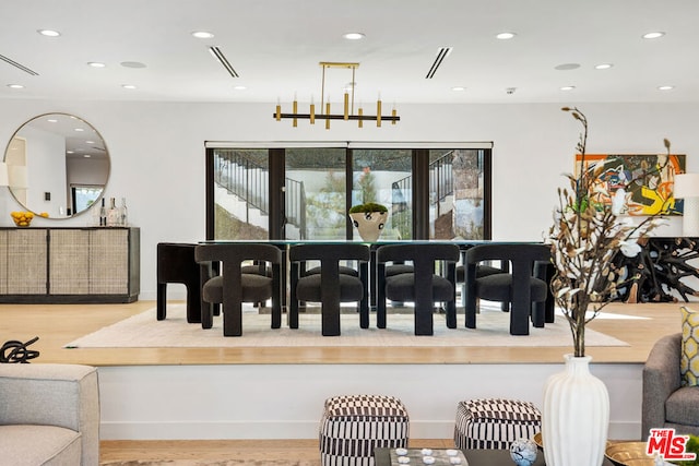 dining space featuring a chandelier and light hardwood / wood-style flooring