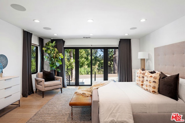 bedroom with light wood-type flooring and access to outside