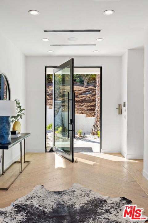 bedroom featuring access to exterior and light hardwood / wood-style floors