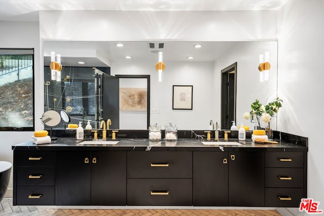 bathroom featuring vanity and an enclosed shower