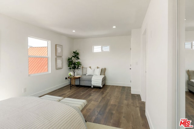 bedroom with dark wood-type flooring