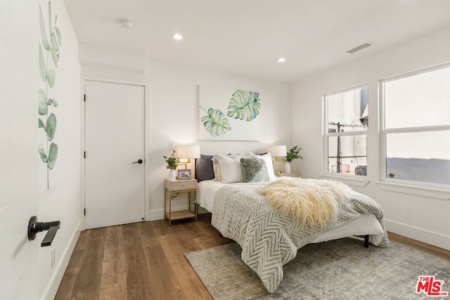 bedroom with dark wood-type flooring