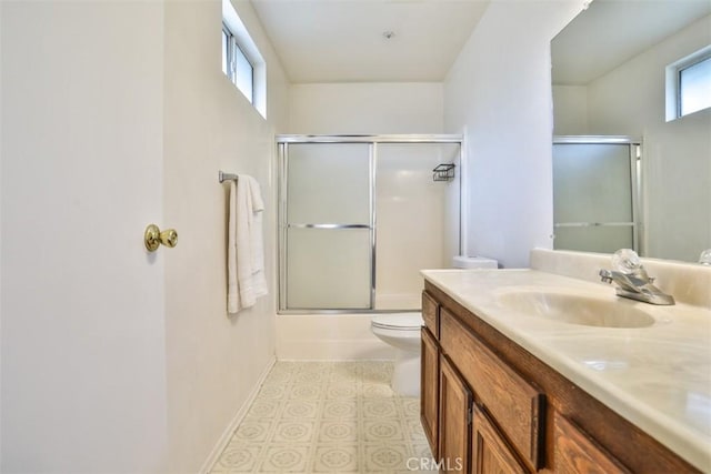 full bathroom with toilet, combined bath / shower with glass door, and vanity