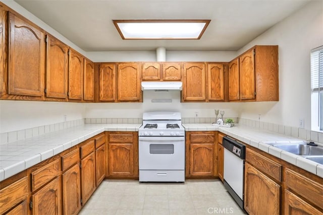 kitchen featuring tile countertops and white appliances