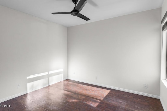 unfurnished room with ceiling fan and dark hardwood / wood-style flooring