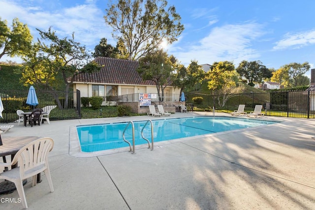 view of swimming pool featuring a patio area