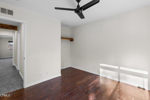 empty room with ceiling fan and dark hardwood / wood-style flooring