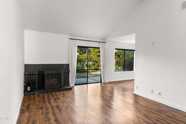 unfurnished living room with dark hardwood / wood-style flooring and high vaulted ceiling