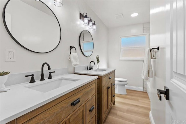 full bathroom featuring toilet, vanity, shower / bath combination, and hardwood / wood-style flooring