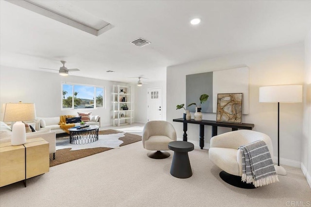 carpeted living room featuring ceiling fan