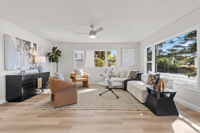 living room featuring ceiling fan and light hardwood / wood-style flooring