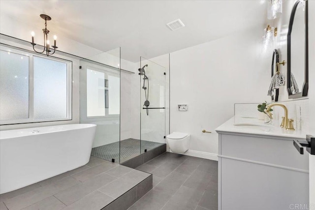 full bathroom featuring vanity, tile patterned flooring, separate shower and tub, toilet, and a notable chandelier