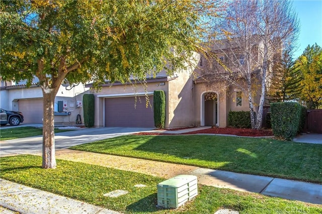 view of front of house with a garage and a front lawn