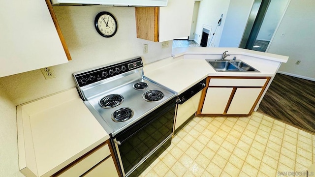 kitchen with kitchen peninsula, electric range, dishwasher, white cabinets, and sink