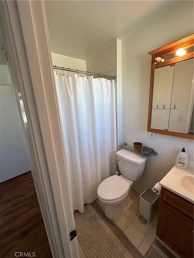 bathroom featuring tile patterned floors, vanity, and toilet