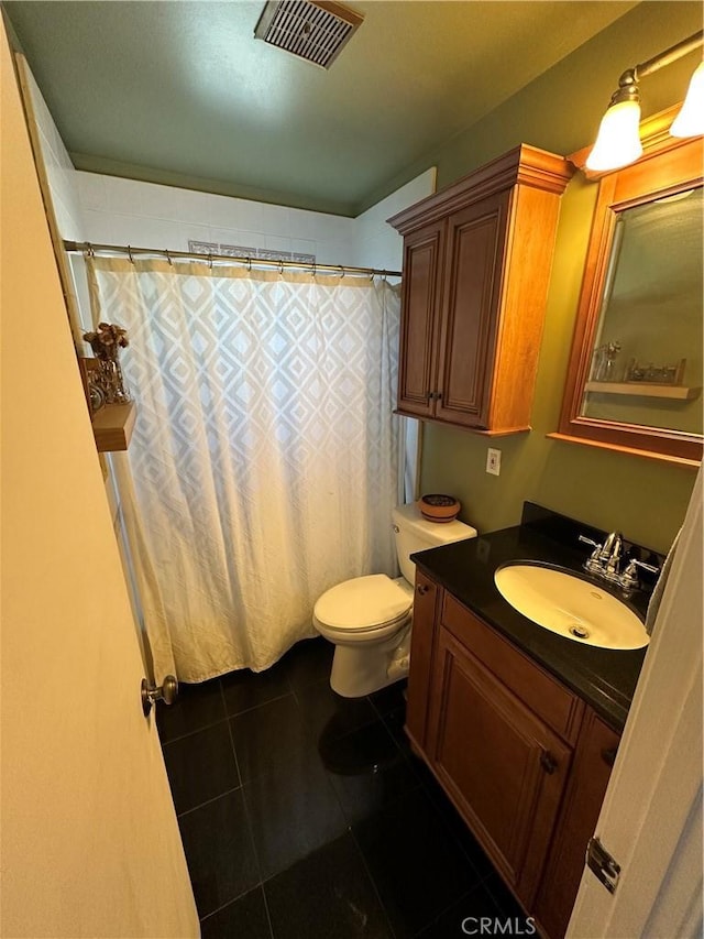 bathroom featuring tile patterned flooring, vanity, a shower with shower curtain, and toilet