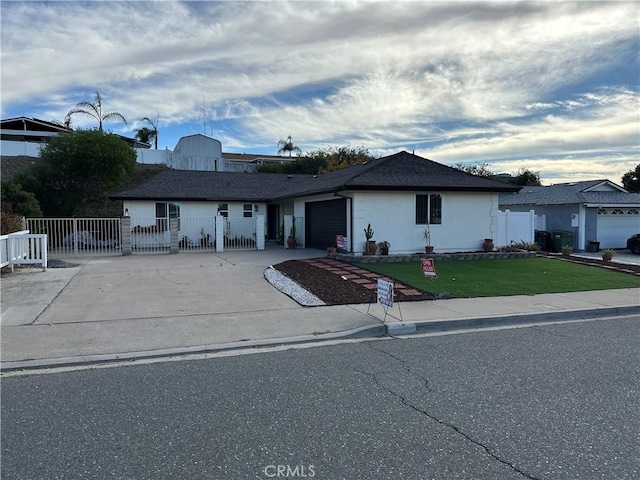 ranch-style home with a front yard and a garage