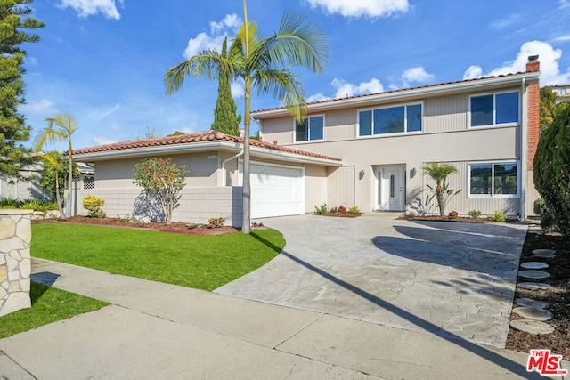 view of front of home featuring a garage and a front lawn