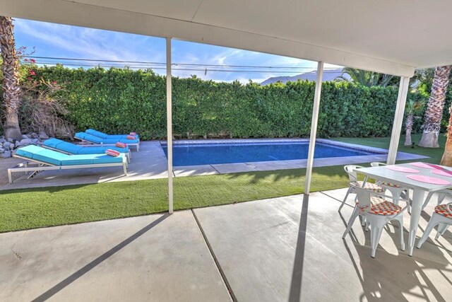 view of pool with a lawn and a patio