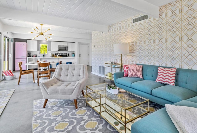 living room featuring beam ceiling, concrete floors, and an inviting chandelier