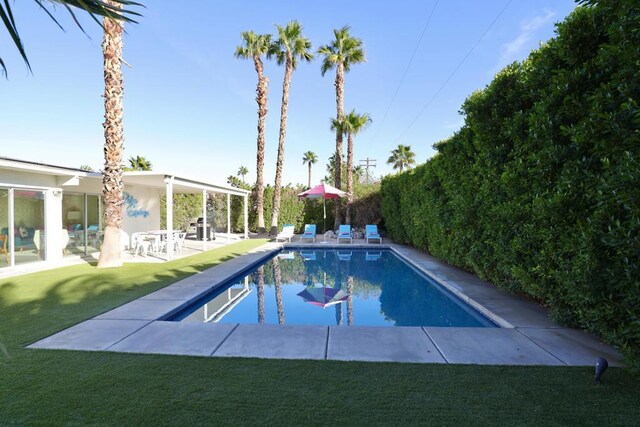 view of pool featuring a yard