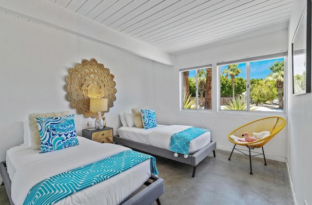 bedroom featuring concrete floors and wood ceiling