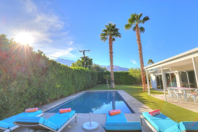 view of swimming pool with a yard and a patio area