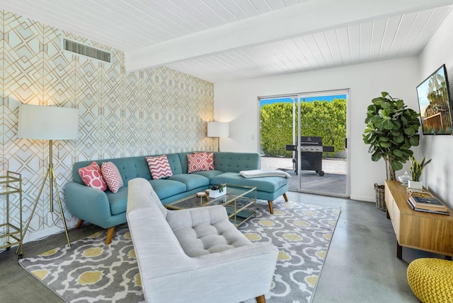 living room with concrete flooring and beamed ceiling