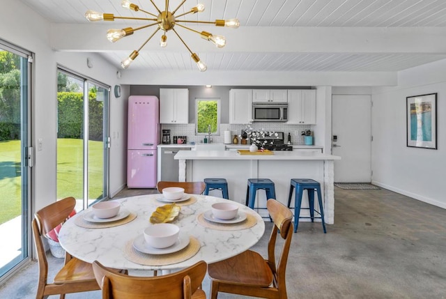 dining room with beamed ceiling and a notable chandelier