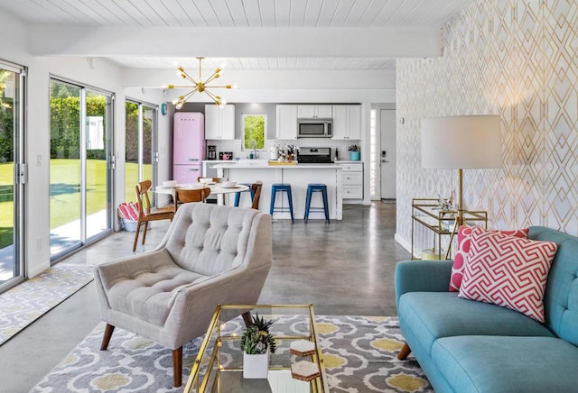 living room with beam ceiling and an inviting chandelier