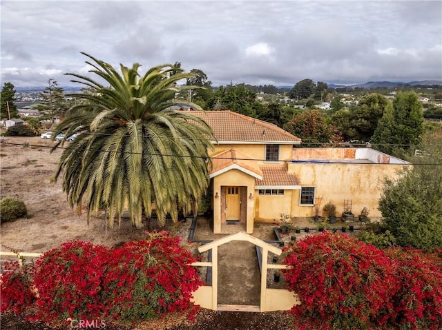 view of front of home with a tile roof and stucco siding