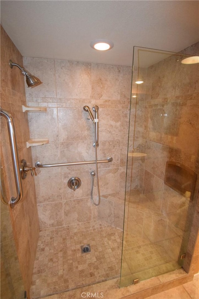 bathroom featuring a shower with door