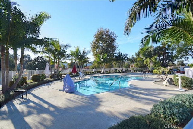 pool featuring a patio and fence