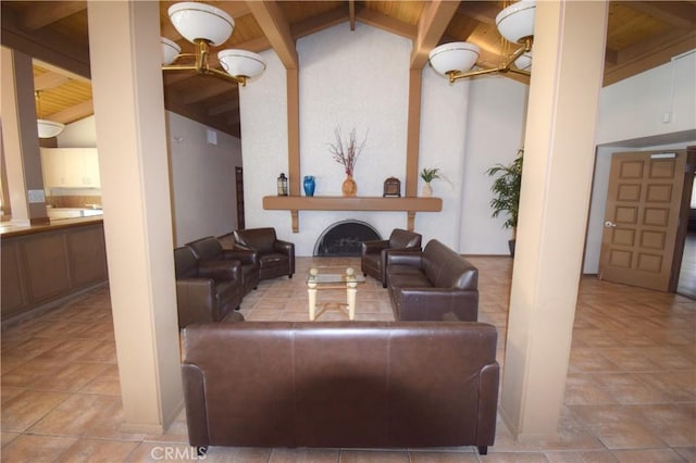 living area with wood ceiling, a notable chandelier, vaulted ceiling with beams, and a fireplace