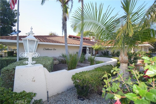 5362 Algarrobo Unit 2O, Laguna Woods, CA 92637 - view of side of home featuring fence, a tile roof, and stucco siding