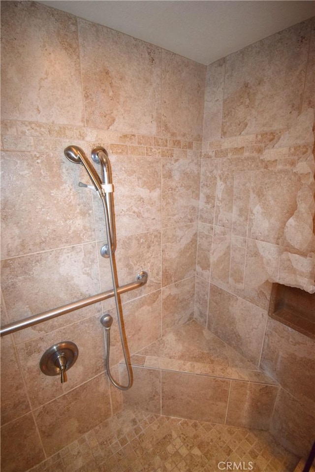 bathroom with tiled shower