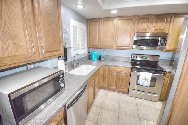 kitchen with light tile patterned flooring, appliances with stainless steel finishes, and sink