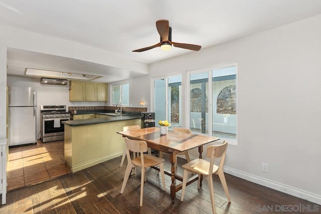 dining space with dark wood-type flooring, ceiling fan, and sink