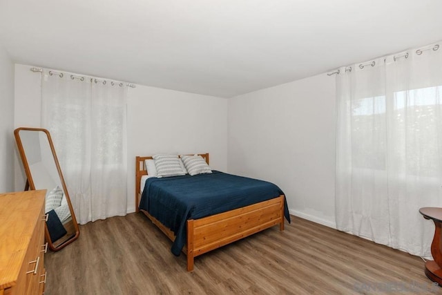 bedroom with wood-type flooring