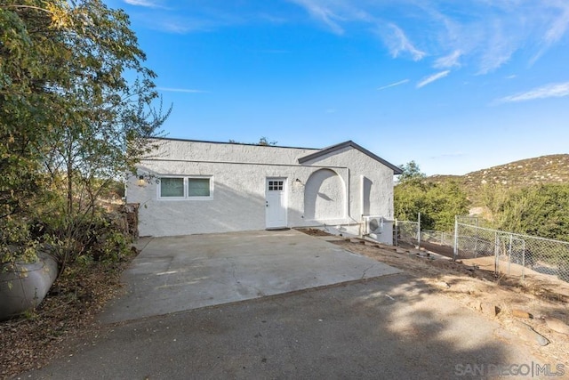 view of front of home featuring a mountain view and a patio