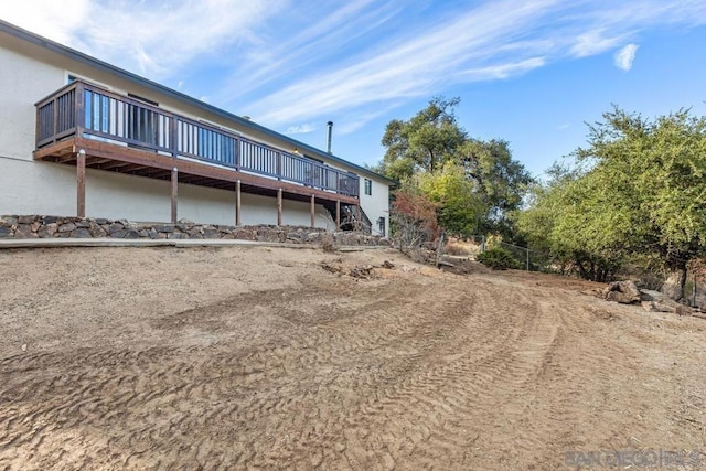 rear view of property featuring a wooden deck